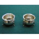 PAIR OF HALLMARKED SILVER OPEN SALTS ON RAISED SUPPORTS,