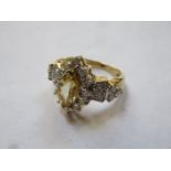 18k GOLD DRESS RING SET WITH YELLOW BERYL AND SURROUNDED BY SMALL DIAMONDS