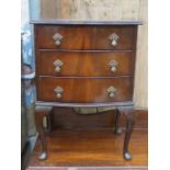 SMALL BOW FRONTED THREE DRAWER CHEST ON CABRIOLE SUPPORTS
