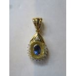 18ct GOLD DROP PENDANT SET WITH CENTRAL BLUE SAPPHIRE COLOURED STONE AND SMALL DIAMONDS