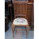 CARVED OAK TAPESTRY SEATED SINGLE CHAIR ON STRETCHERED SUPPORTS
