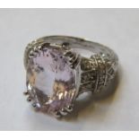 14k WHITE GOLD DRESS RING SET WITH CENTRAL AMETHYST COLOURED STONE AND SMALL DIAMONDS