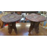 TWO SIMILAR HEAVILY CARVED INDIAN STYLE OCCASIONAL TABLES