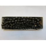 FOUR VARIOUS STRANDS OF BLACK COSTUME BEADS