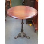 POLISHED TOPPED CIRCULAR PUB TABLE ON PIERCEWORK DECORATED CAST IRON SUPPORTS