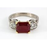 An 18ct yellow and white gold ring set with a cushion cut ruby and brilliant cut diamond set