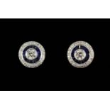 A matching pair of 18ct white gold (stamped 750) sapphire and diamond set halo stud earrings.