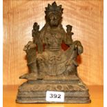 A Tibetan cast iron figure of a seated Buddhist deity.