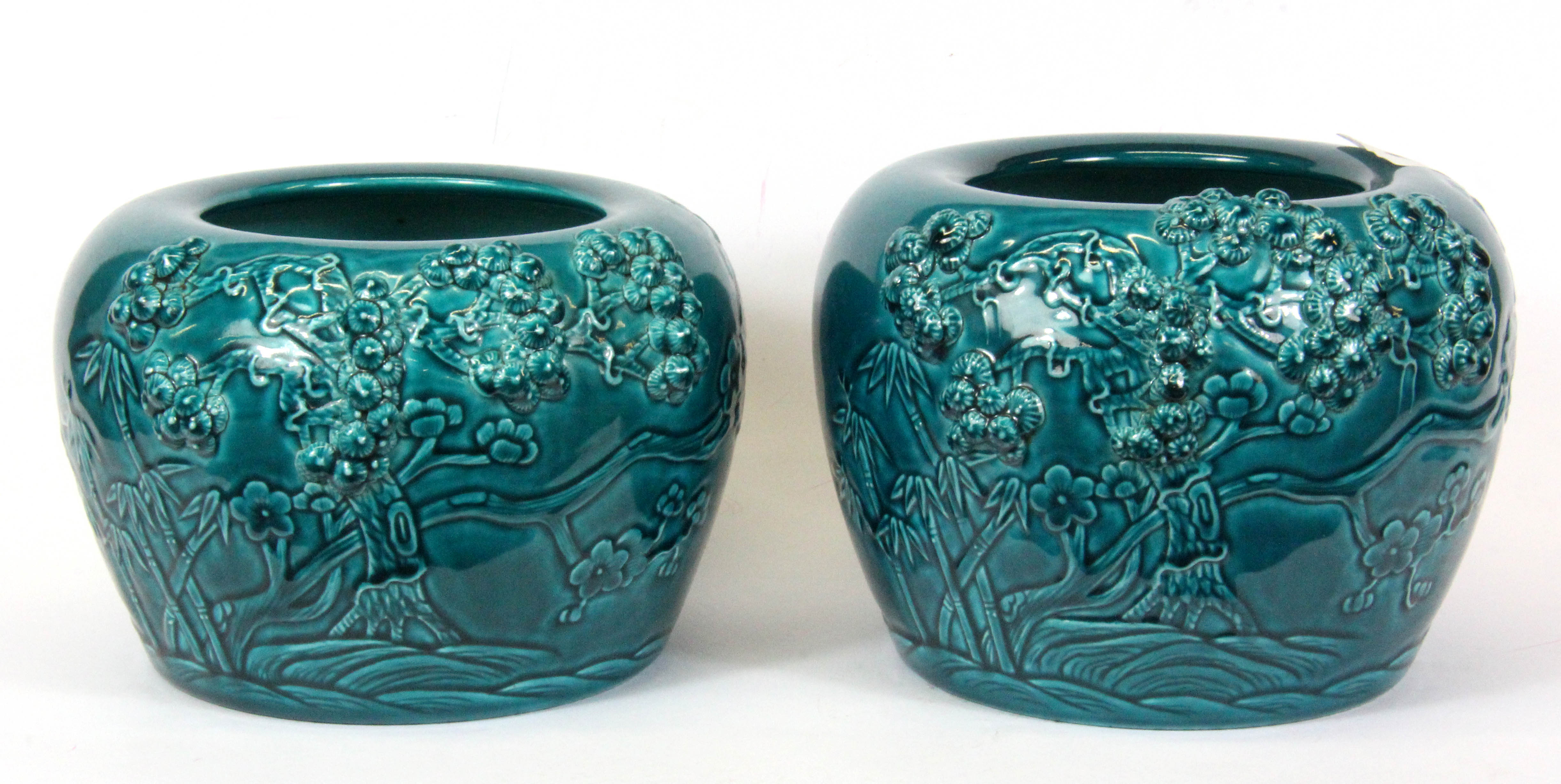 A pair of Chinese turquoise glazed and relief decorated bowls, H. 12cm, Dia. 15cm.