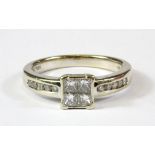 An 18ct white gold princess cut diamond set cluster ring with diamond set shoulders, approx. 0.5ct