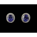 A pair of 18ct white gold (worn stamp 750) tanzanite and diamond set cluster stud earrings.