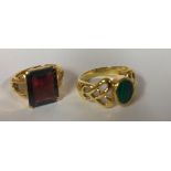 Two .925 silver gilt rings, one set with malachite the other with garnet.