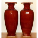 A pair of large 20th Century Chinese Sang de Boeuf glazed porcelain vases, H. 48cm.