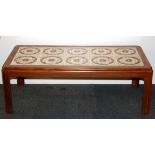 A 1970's tile topped teak coffee table, 111 x 51 x 40cm.