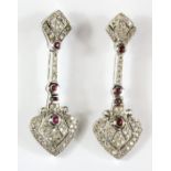 A pair of 9ct white gold diamond and ruby set drop earrings, L. 4cm.