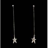 A pair of 18ct white gold diamond set star drop earrings, L. 5cm.