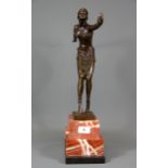 A large Art Deco style bronze figure of a young woman on a red and black marble base after Chiparus,