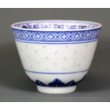 A very fine Chinese rice grain glazed and hand painted porcelain tea bowl.