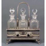 An Edwardian silver plated three bottle tantalus, W. 28cm, H. 34cm.