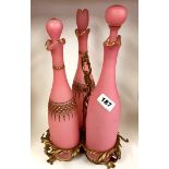 A 19thC French ormolu tantalus stand with three pink opaline glass decanters. H.40cms