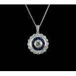 An 18ct white gold (stamped 750) sapphire and diamond set halo pendant and chain, L. 1.6cm.