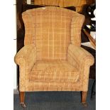 An antique wing back armchair.