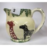 A Windermere pottery jug with sponge decoration of African animals. H.12cms