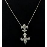 An 18ct white gold (stamped 750) diamond and pearl fleur de lys shaped necklace, L. 34cm.