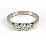 An 18ct white gold three brilliant cut diamond set ring, (P.5).