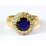 An antique yellow metal (worn gold hallmark 15ct gold) blue stone and diamond set cluster ring, J).