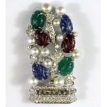 An 18ct white gold (stamped 750) contemporary pendant set with diamonds, carved emeralds, rubies and