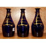 Three early 19th Century gilt blue glass decanters, H. 19cm.