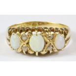 A yellow metal (tested 18ct yellow gold) opal and diamond set ring, (L).