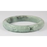 A carved jade bangle, Dia. 7.5cm.