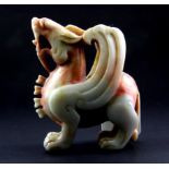 An impressive 19th/ early 20th Century Chinese carved mixed colour jade/ hardstone figure of a