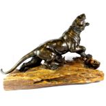 An important large Japanese Meiji period bronze figure of a tiger with glass eyes on a natural form