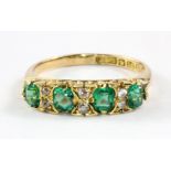 An antique 18ct yellow gold diamond and green stone ring (one stone replaced by cz), (O).