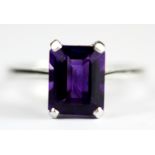 A 9ct white gold emerald cut amethyst set ring, (R.5).