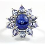 A 925 silver cabochon cut sapphire and tanzanite set cluster ring, (L.5).