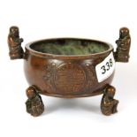 A Chinese cast bronze offering censer mounted with young monks, W. 14cm H. 9.5cm.