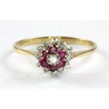 A 9ct yellow and white gold ruby and diamond set cluster ring, (P.5)