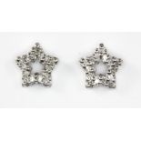 A pair of 9ct white gold diamond set star shaped stud earrings, L. 0.8cm.