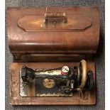 An antique sewing machine with inlaid wooden case.