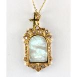 A yellow metal (tested 18ct gold) pendant set with diamonds and carved mother of pearl on a 9ct gold