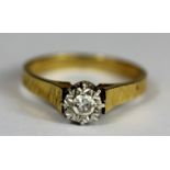 An 18ct yellow gold diamond set solitaire ring, (M).