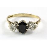 A 9ct yellow and white gold sapphire and diamond set three stone ring, (P).