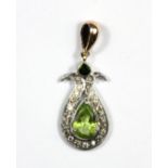 A white and rose metal (tested 9ct gold and silver) pendant set with peridot, emerald and