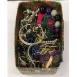 A box of mixed costume jewellery.