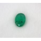 An unmounted 0.74ct oval cut emerald, 7 x 5 x 2.78mm, with a HKD report.