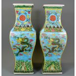 A pair of 19th/ 20th Century Chinese hand painted porcelain vases decorated with dragon and phoenix,